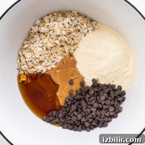 A bowl with ingredients for a chocolate chip cookie.