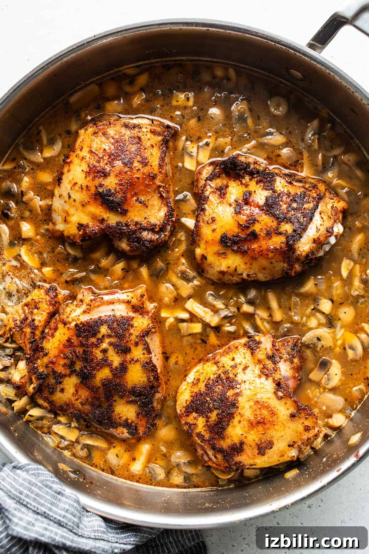 One-Pot Creamy Mushroom Chicken and Rice Recipe 4 Chicken breasts in a pan with mushrooms and tomatoes.