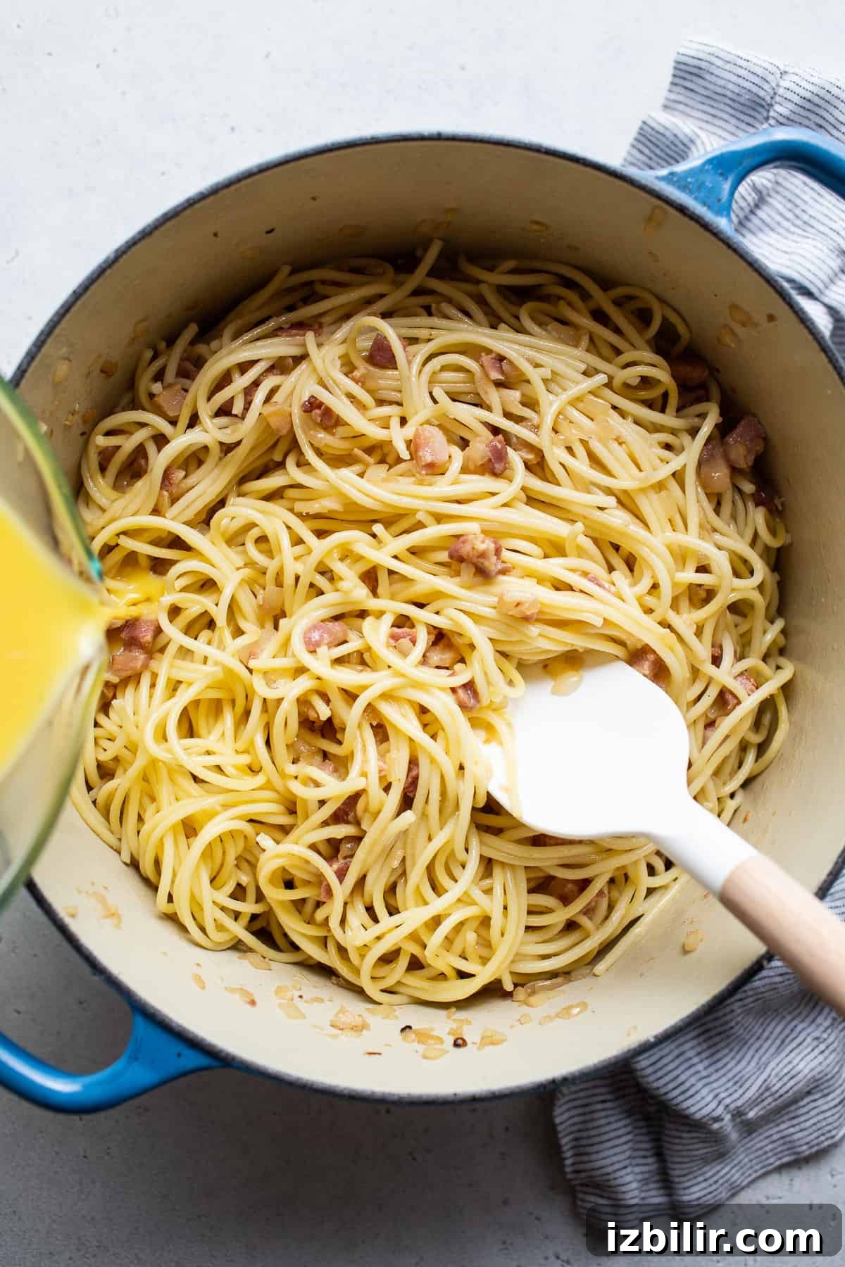 Classic Creamy Carbonara Recipe 4 A pot of spaghetti with bacon and orange juice.