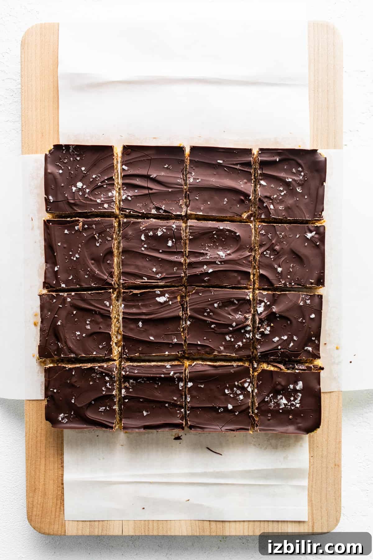Squares of chocolate bars on a cutting board.