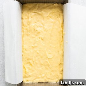 Zesty Orange Cake Recipe with Citrus Glaze 10 A square of yellow cake in a baking pan.