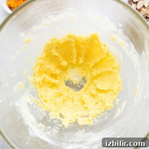 Zesty Orange Cake Recipe with Citrus Glaze 11 A glass bowl filled with ingredients for a recipe.