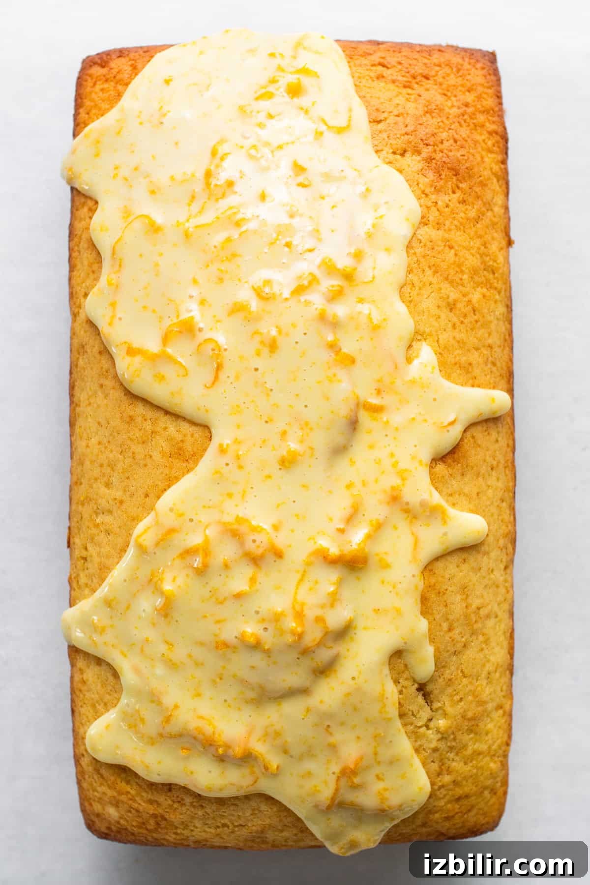 Zesty Orange Cake Recipe with Citrus Glaze 3 A piece of cake with icing on it.
