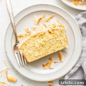 Zesty Orange Cake Recipe with Citrus Glaze 5 coconut loaf on plate.