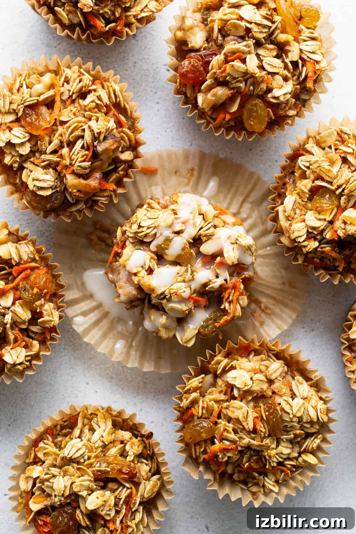 A group of granola muffins on a white surface.