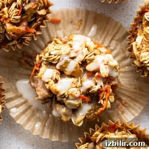 A group of muffins with granola and carrots.