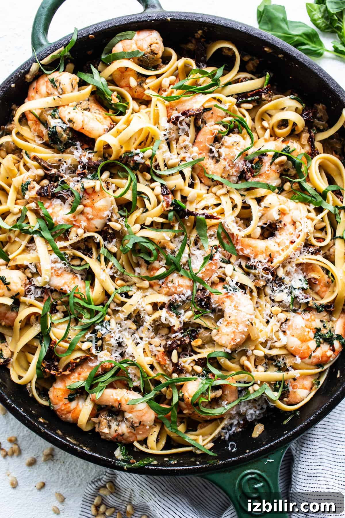 Creamy Tuscan Shrimp Linguine Recipe 4 A skillet filled with pasta and shrimp.