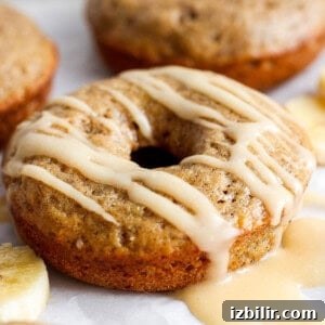 A banana-flavored donut with a glaze topping on a white background.