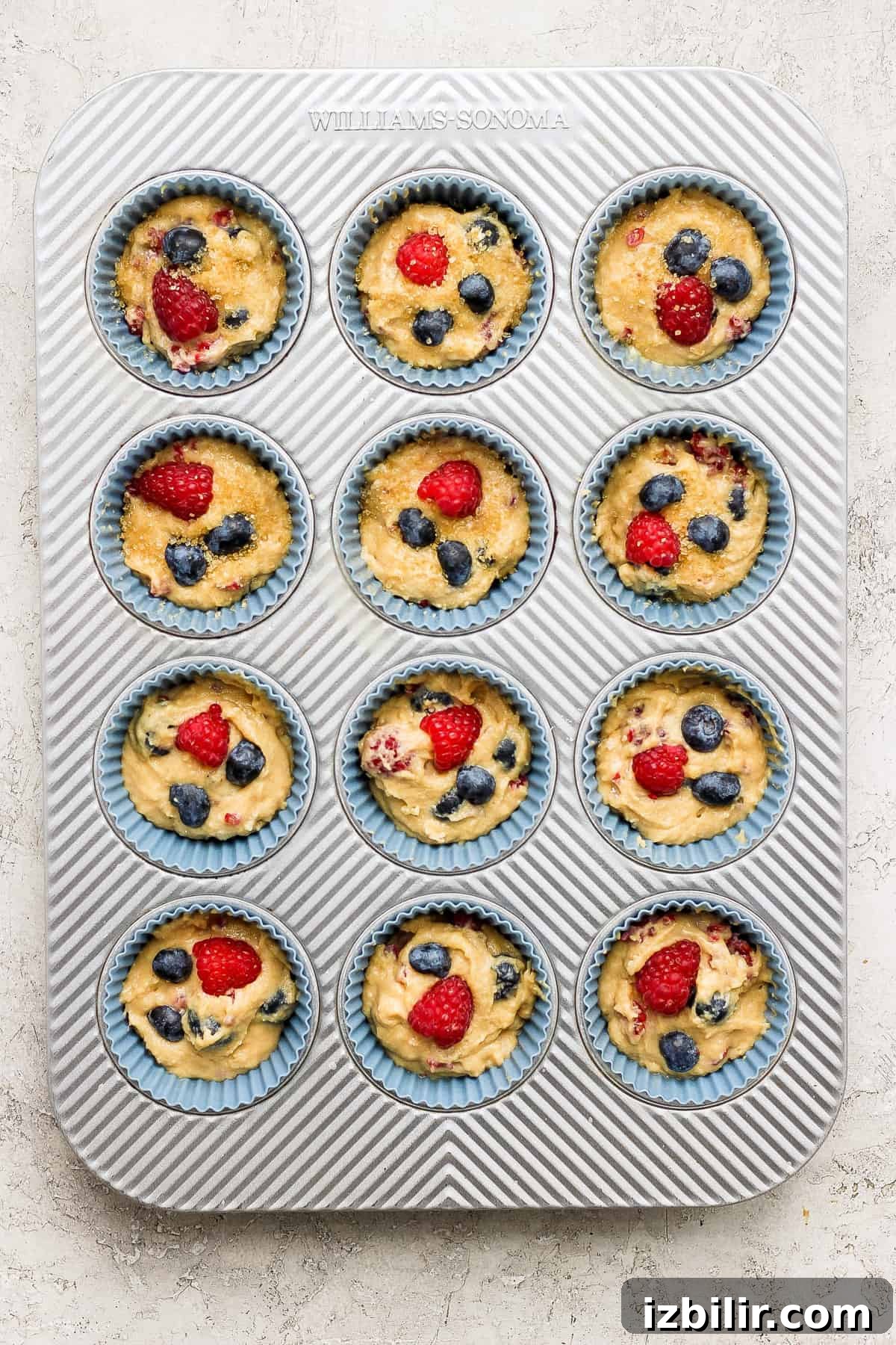 Greek Yogurt Berry Muffins with Mixed Berries 3 A muffin tin filled with muffins and berries.