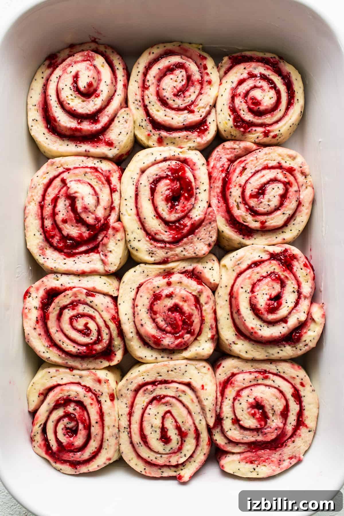 Raspberry roll ups in a white dish.