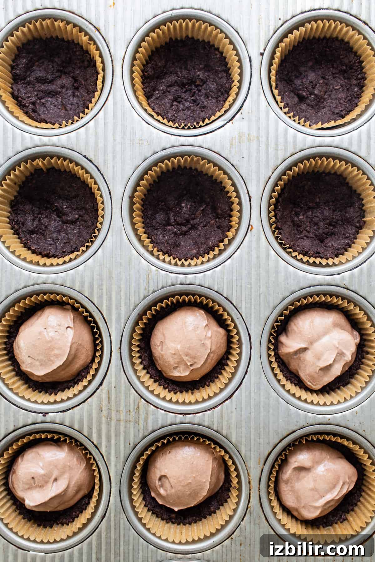 Thin Mint Chocolate Protein Mousse Cups 4 Chocolate cupcakes in a muffin tin.