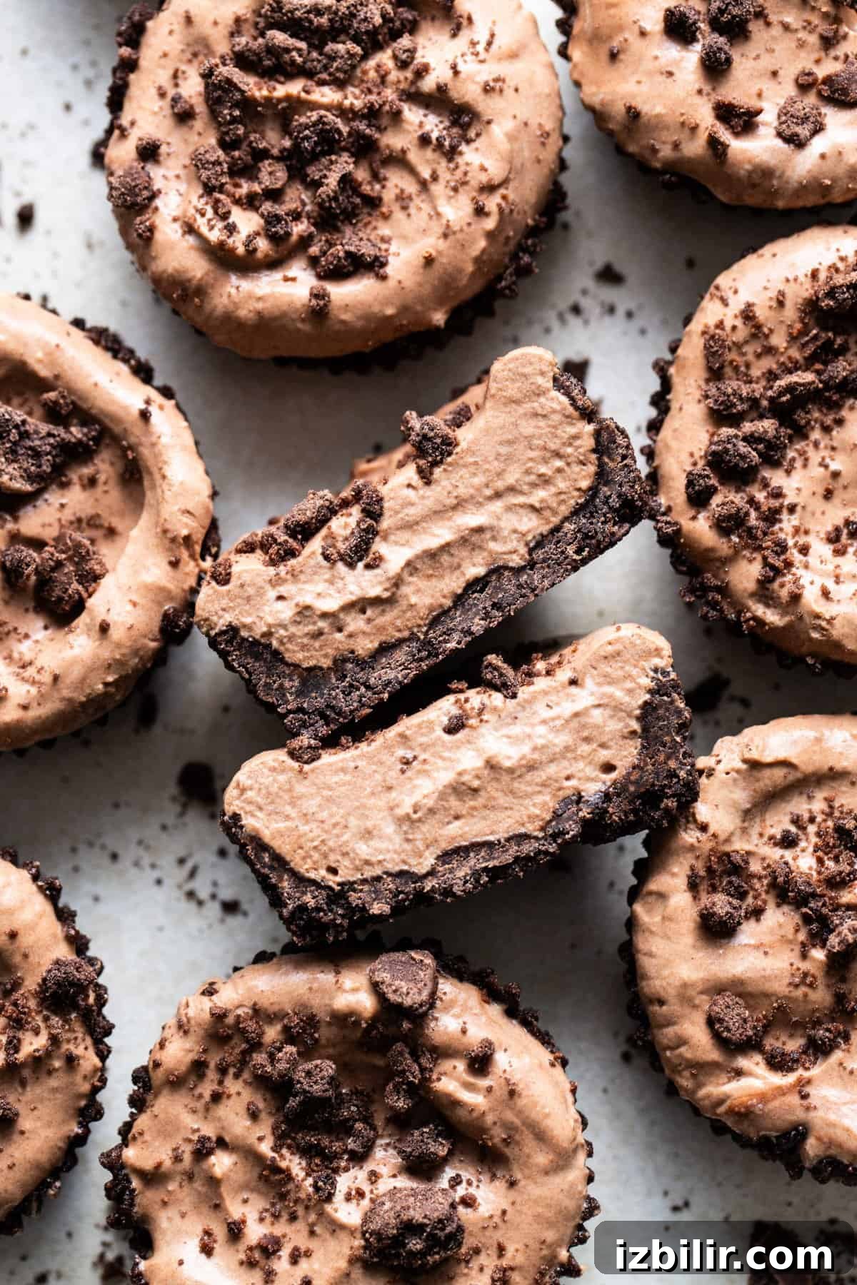Thin Mint Chocolate Protein Mousse Cups 6 A group of chocolate cupcakes with a bite taken out of them.