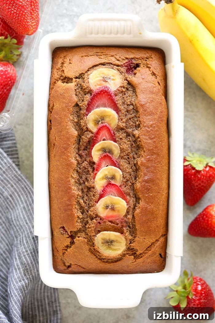 Moist Strawberry Banana Bread Recipe 5 Sliced strawberry banana bread on a wooden board