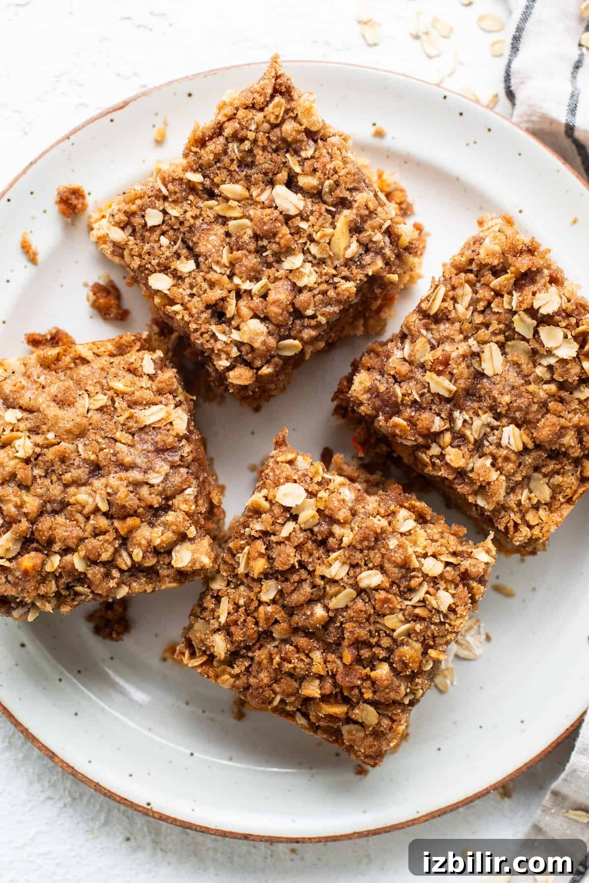 Spiced Carrot Coffee Cake with Cream Cheese Glaze 2 Oat bars on a plate with a napkin.