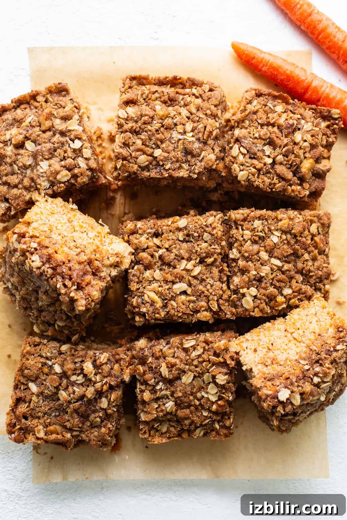 Spiced Carrot Coffee Cake with Cream Cheese Glaze 5 Carrot bars with oats and carrots on a cutting board.