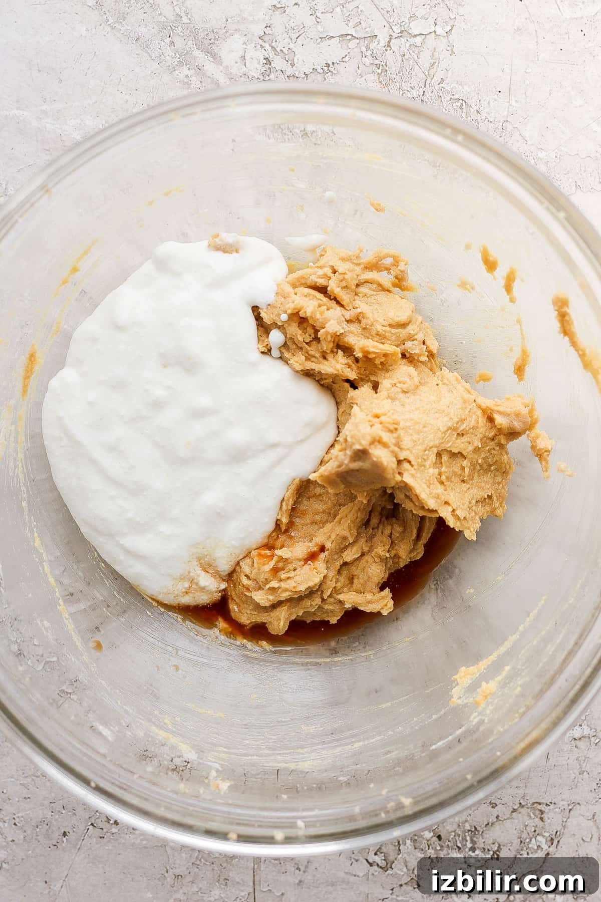 Chewy Chocolate Chip Cookies with Cottage Cheese 3 The ingredients for peanut butter cookie dough in a glass bowl.