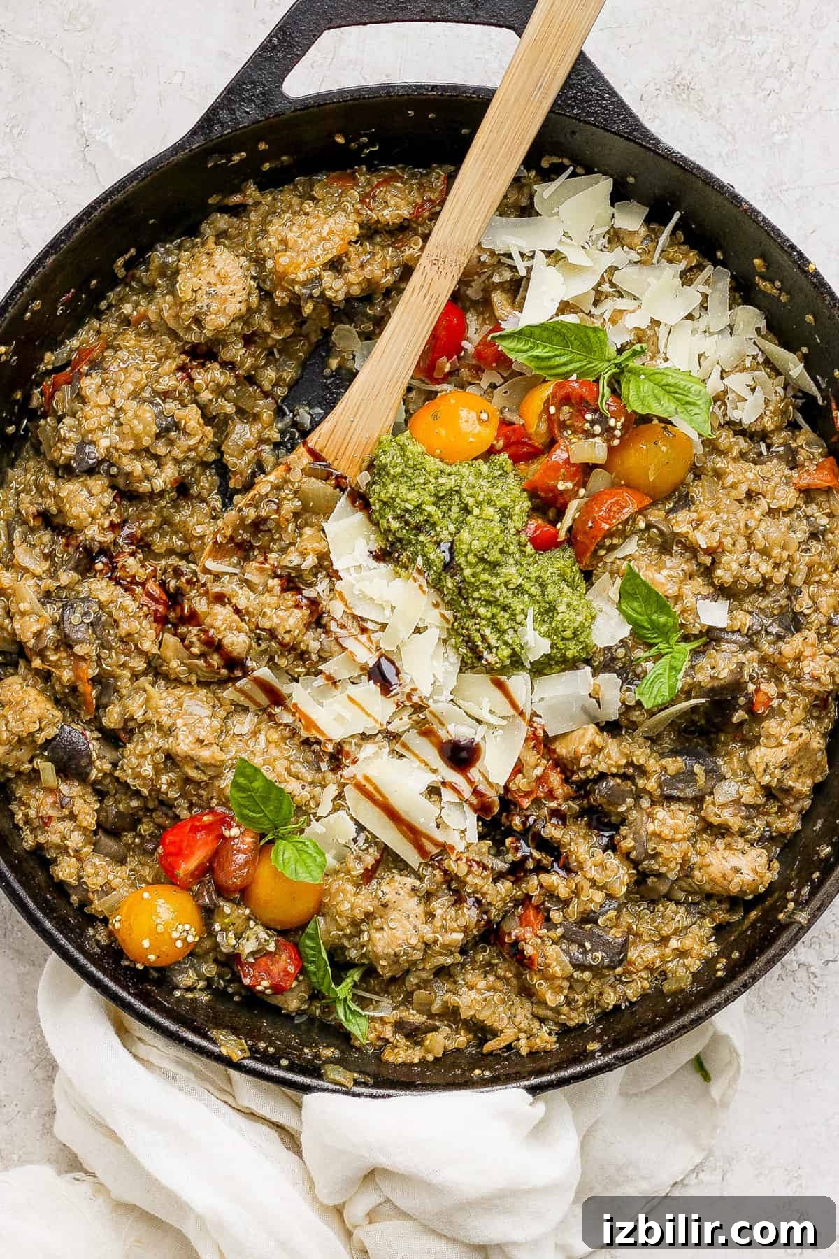 One-Pot Pesto Chicken and Quinoa Skillet Recipe 7 A skillet filled with vegetables and pesto.