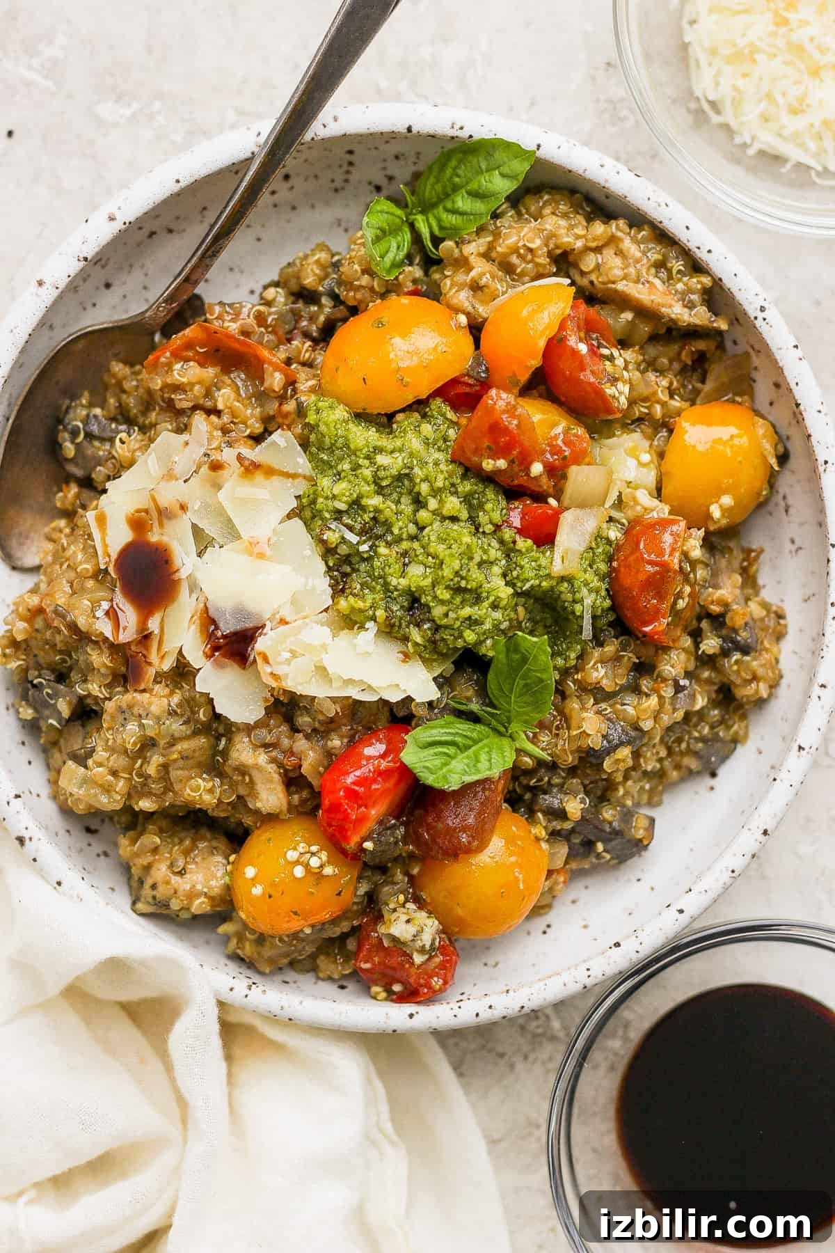 One-Pot Pesto Chicken and Quinoa Skillet Recipe 8 A bowl of pasta with tomatoes and pesto.