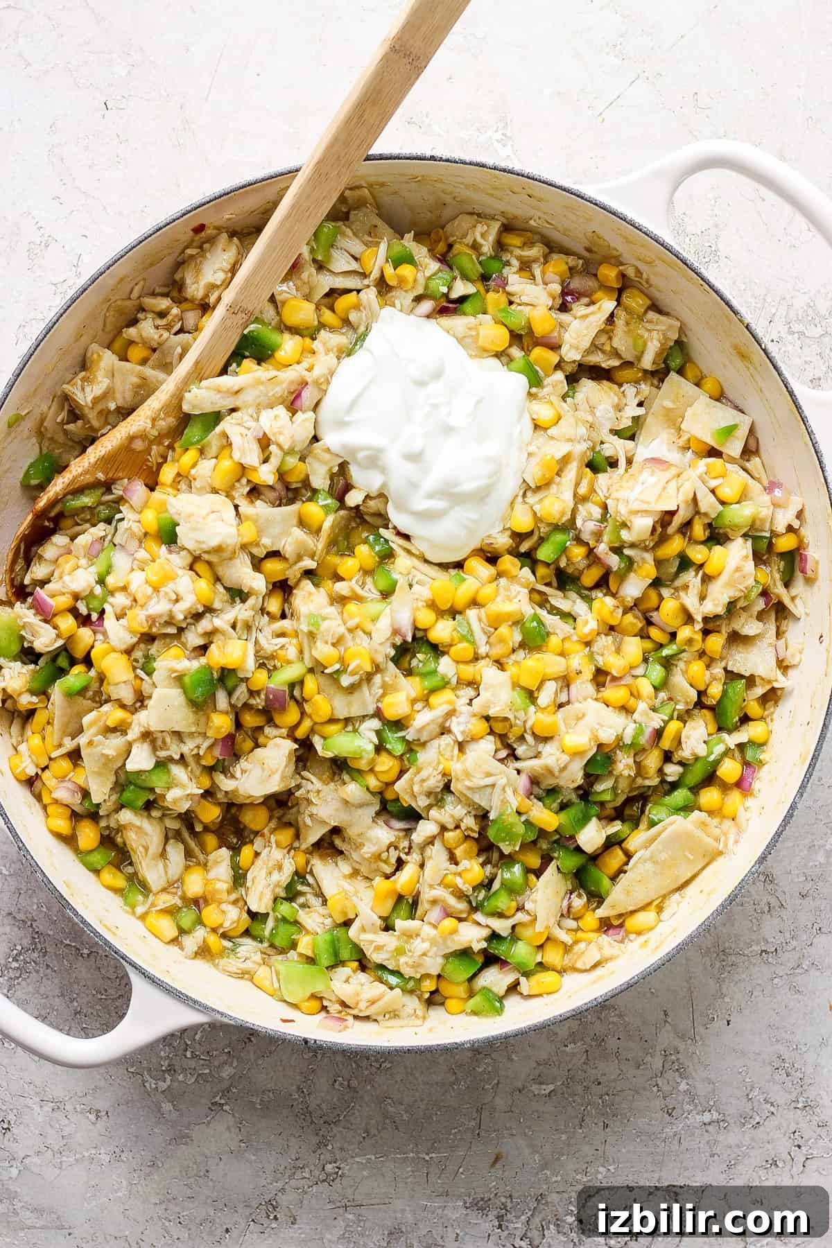 A skillet filled with corn and sour cream.