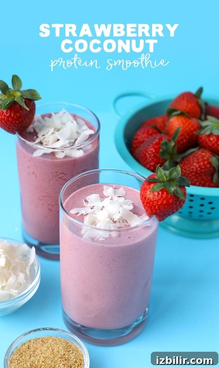 two strawberry coconut protein smoothies next to ingredients in bowls