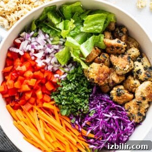 A white bowl filled with asian chicken salad.