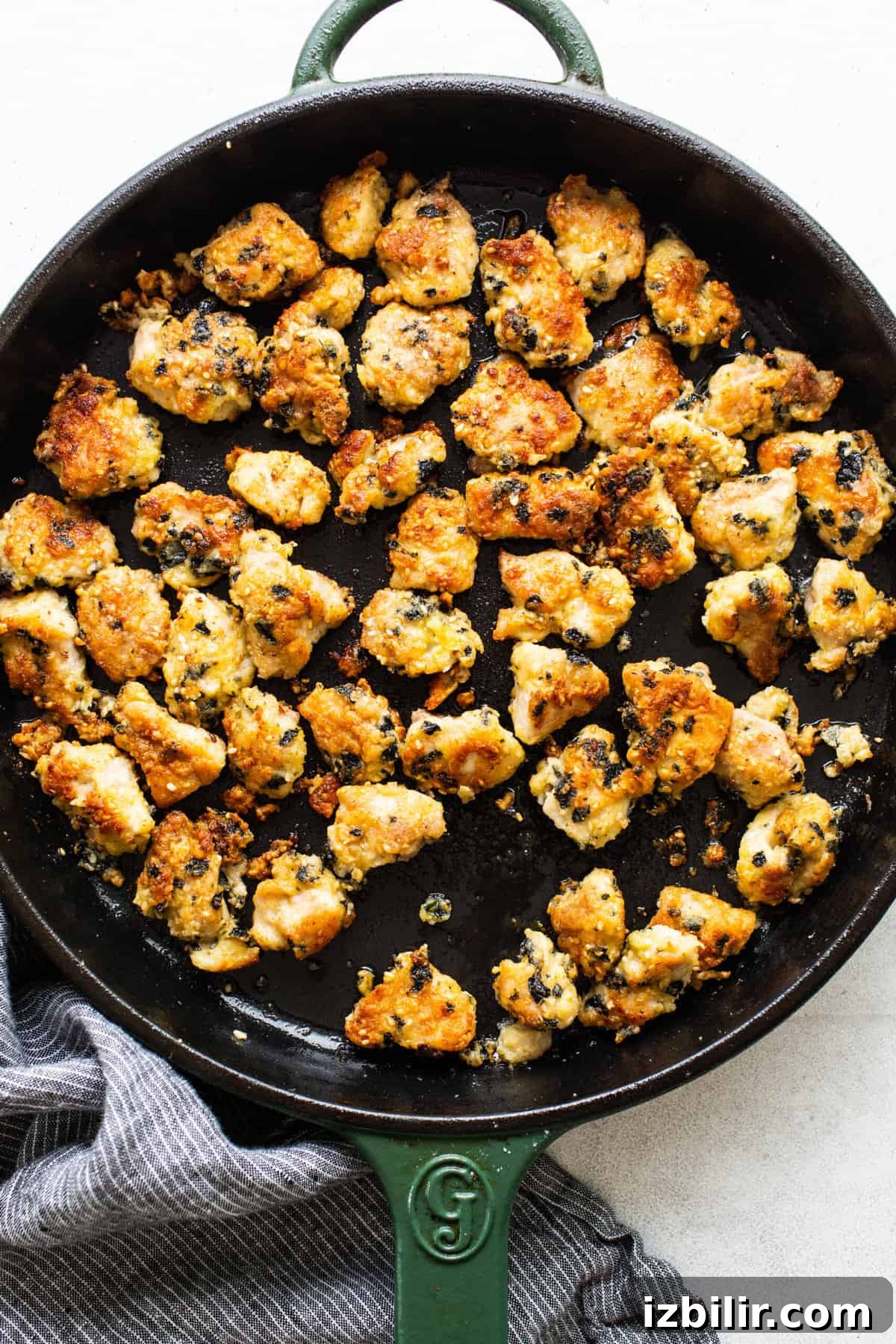Pan searing chicken in a skillet.
