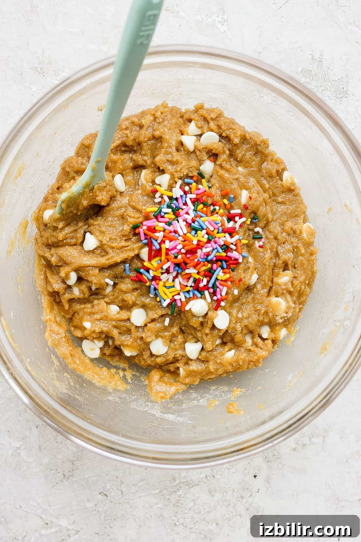 White Chocolate Funfetti Blondies Recipe 3 A bowl of brown dough with sprinkles.