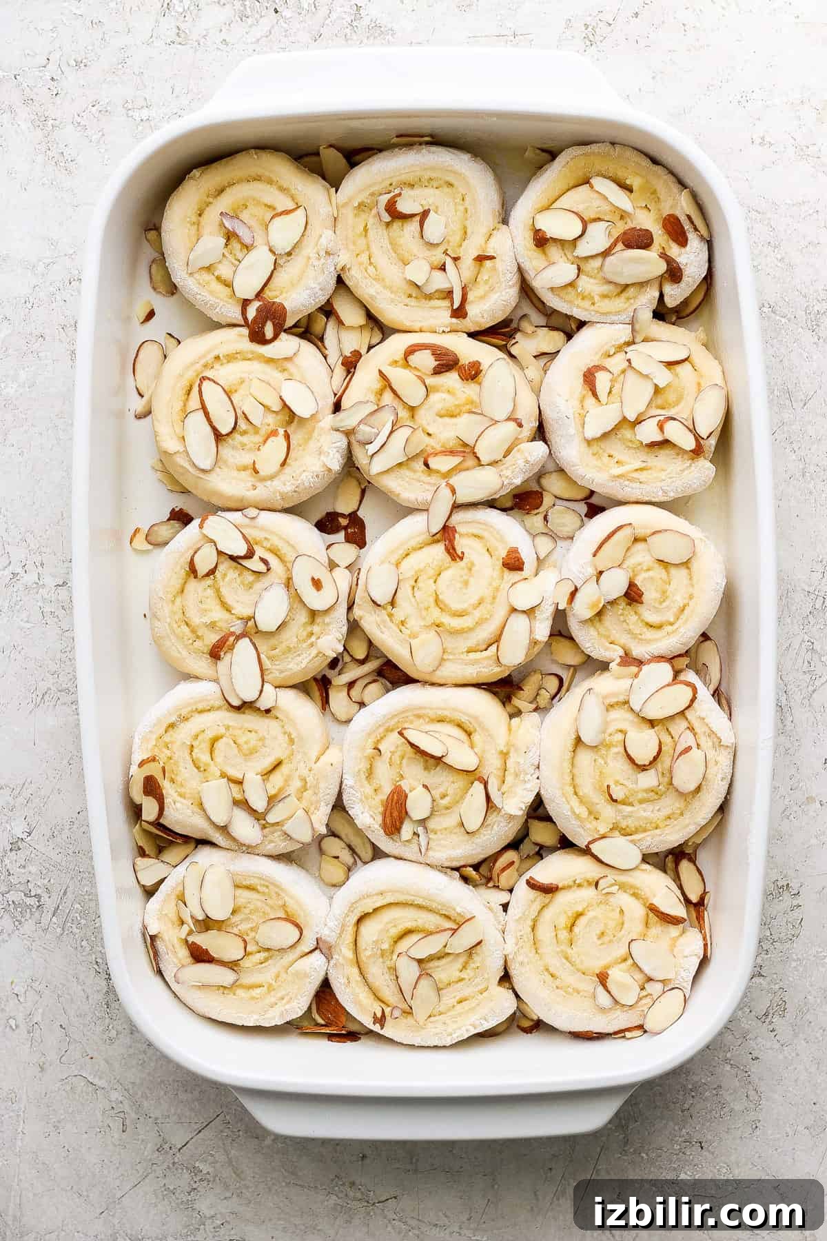 Sliced almond-topped rolls in baking dish