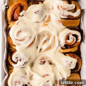 Freshly baked almond-topped rolls in white dish
