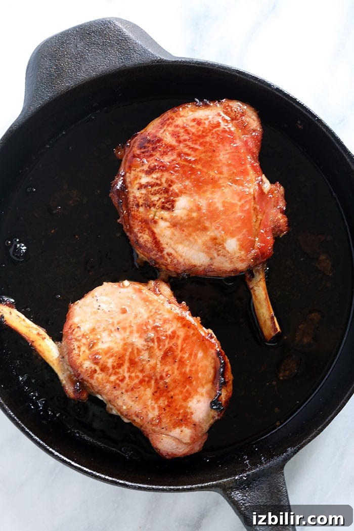 2 pork chops in cast iron skillet