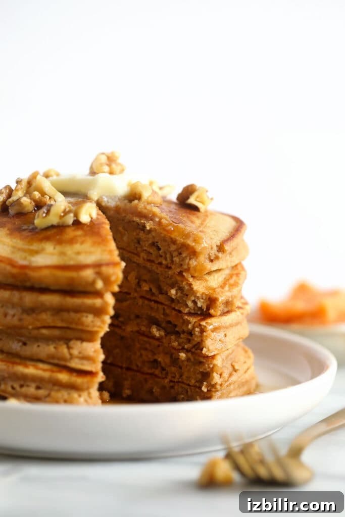 Fluffy Sweet Potato Pancakes Recipe 2 A stack of sweet potato pancakes on a plate.
