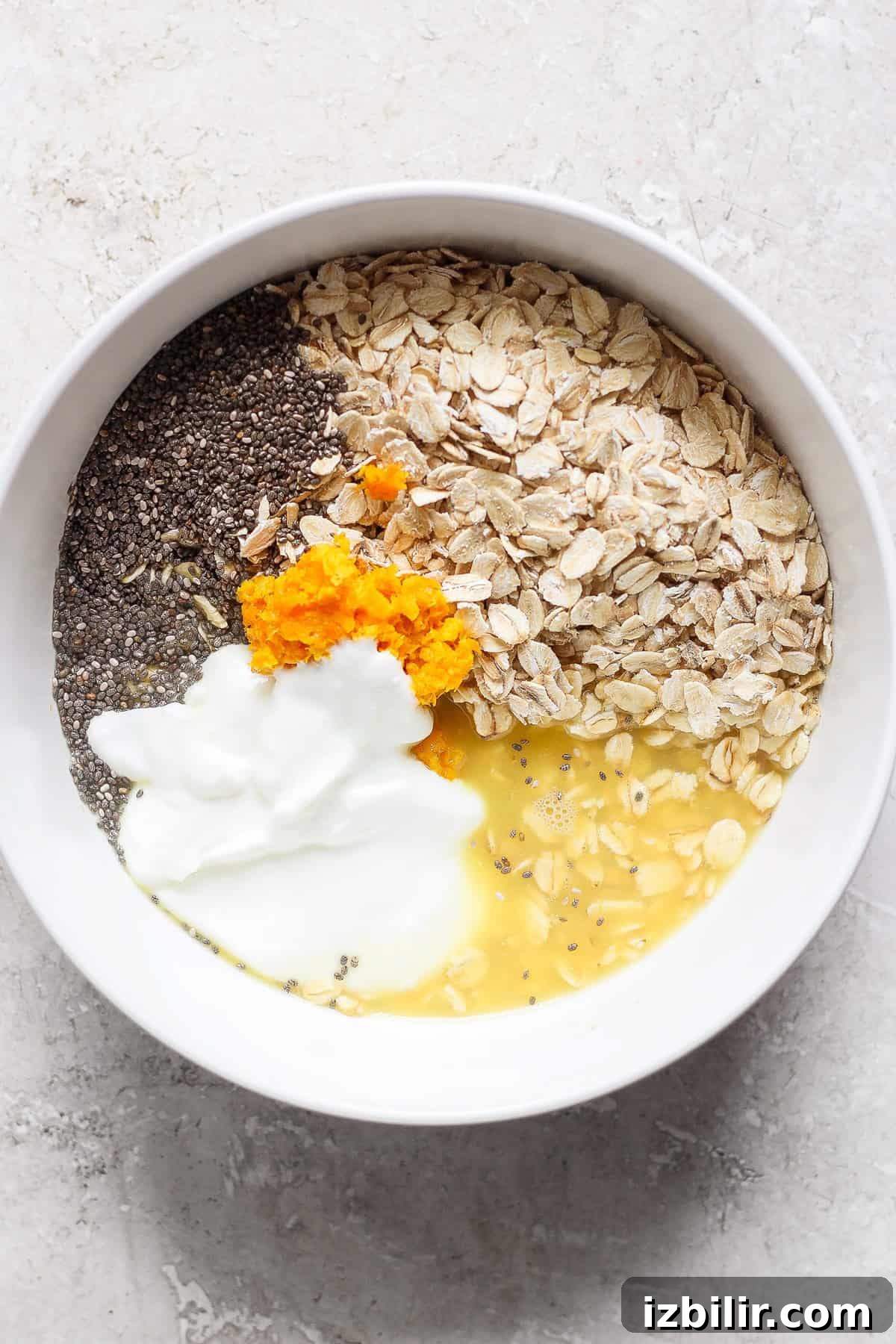 Orange Creamsicle Overnight Oats Recipe 3 Bowl of oats, chia seeds, orange zest and yogurt ready to be mixed for overnight oats