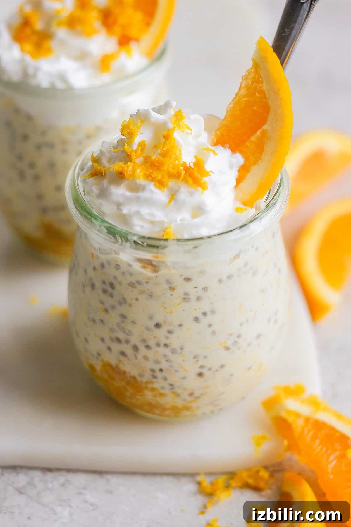 Orange Creamsicle Overnight Oats Recipe 5 Two jars of creamy overnight oats topped with whipped cream and orange slices