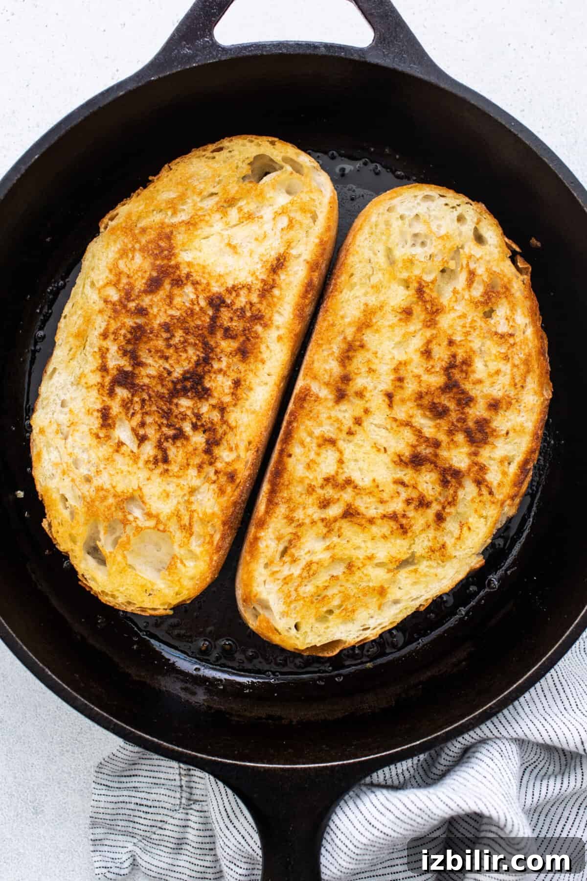 Classic British Beans on Toast Recipe 3 Two slices of french toast in a cast iron skillet.