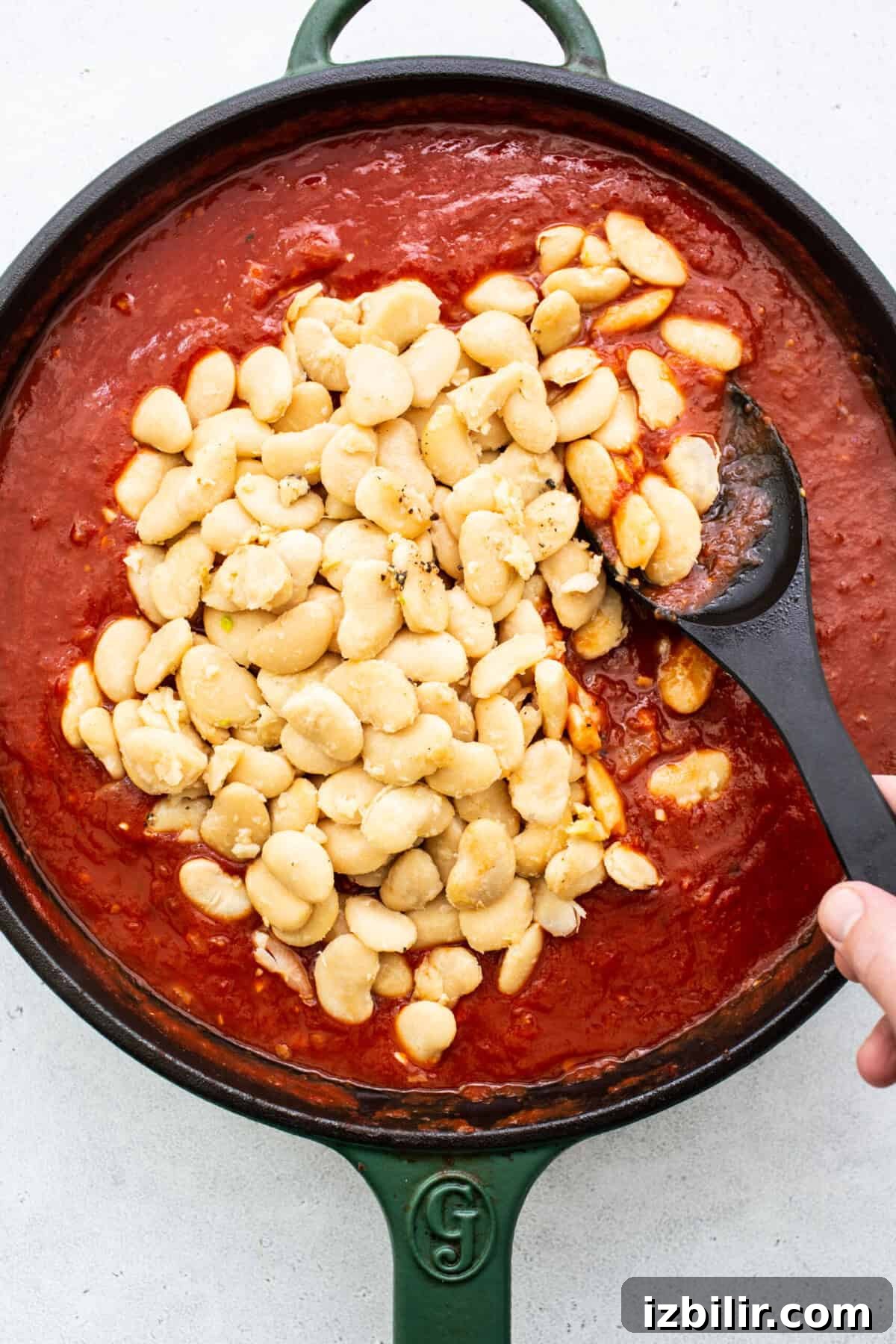 Classic British Beans on Toast Recipe 5 A skillet filled with beans and sauce.