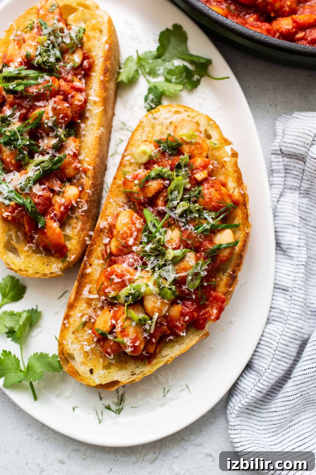 Classic British Beans on Toast Recipe 6 Two slices of bread topped with chicken and parsley.