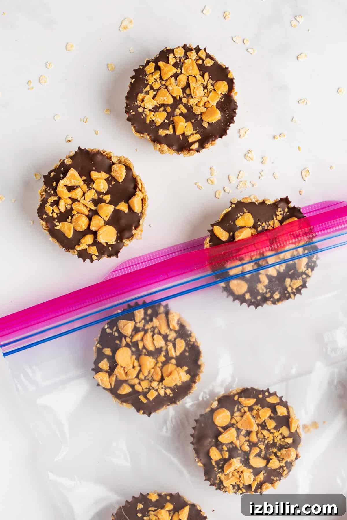 Pumpkin Spice Oatmeal Cups Recipe 5 Five chocolate peanut butter cups topped with crushed peanuts, some inside a ziplock bag.