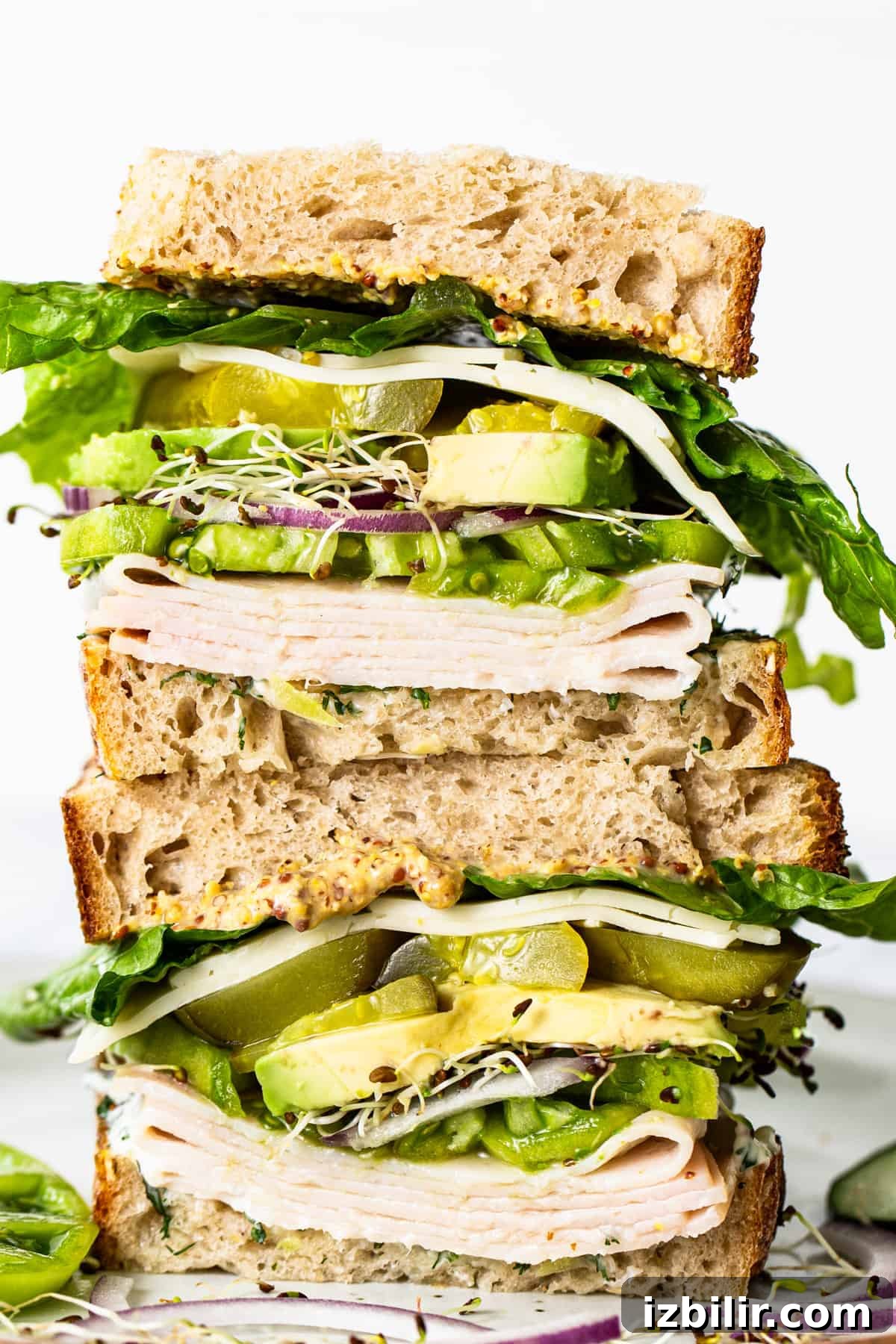 Classic Turkey Sandwich Recipe You Will Love 2 Stacked turkey sandwich with greens and avocado