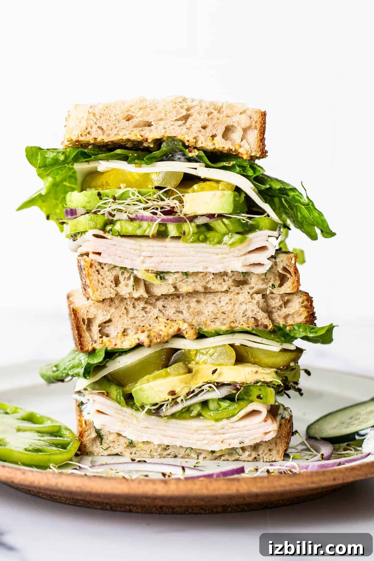 Classic Turkey Sandwich Recipe You Will Love 5 Tall stacked turkey sandwich with layers of cheese, avocado, lettuce and sprouts