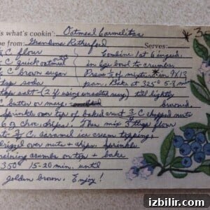 A handwritten recipe card for Carmelita bars with step-by-step instructions and a blue floral illustration on the right.