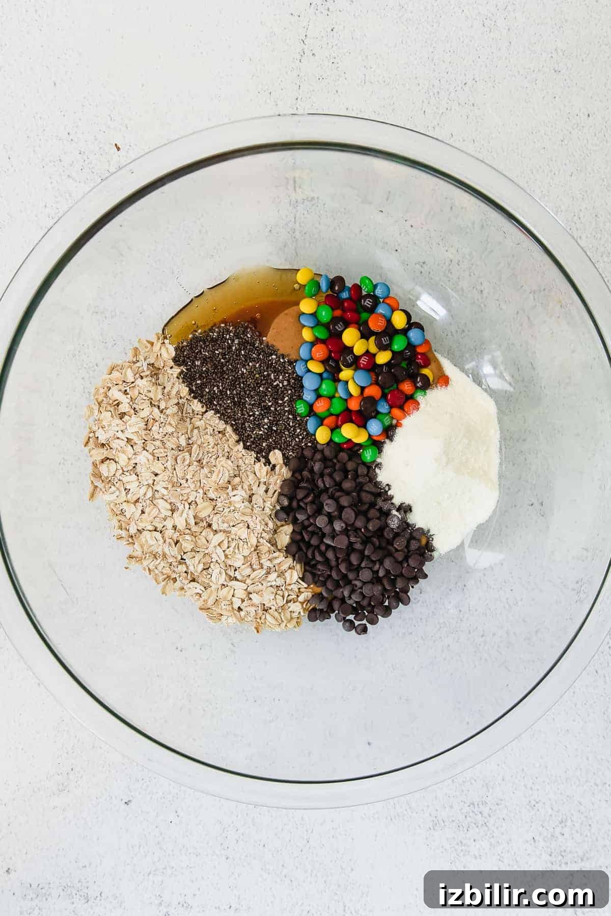 Oats, chocolate chips, marshmallows and chocolate chips in a bowl.