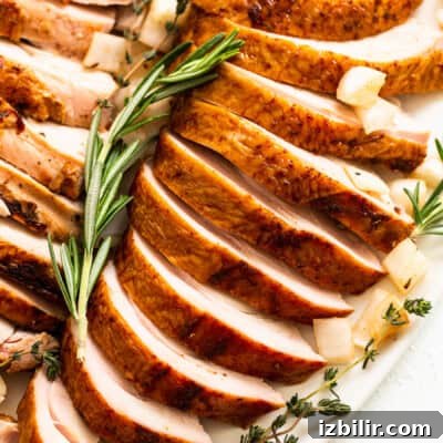 Smoked turkey breast sliced on a plate.