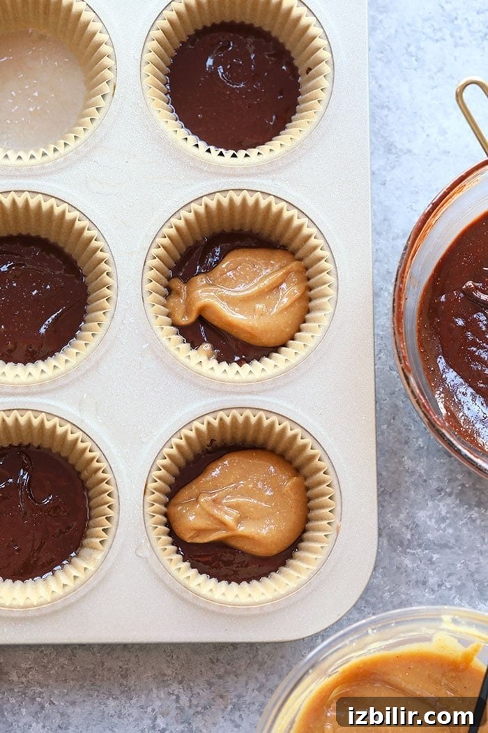 Low-Sugar Peanut Butter Cups Recipe 3 Melted chocolate and peanut butter in cups