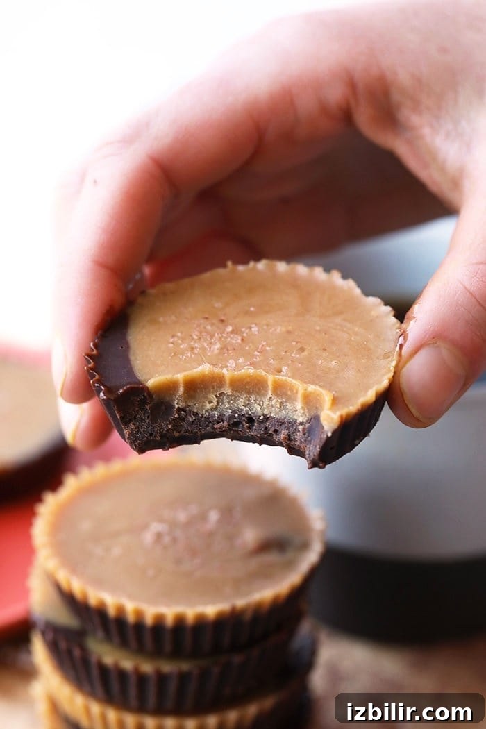 Low-Sugar Peanut Butter Cups Recipe 4 Healthy peanut butter with a bite taken out