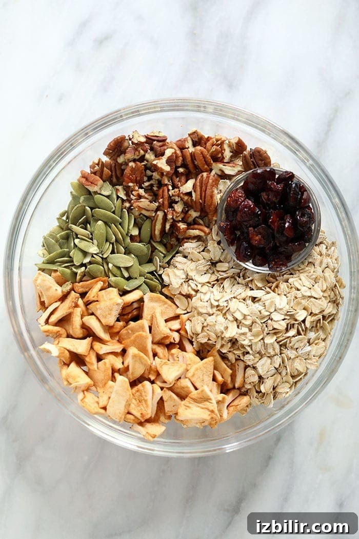 Ingredients for apple cinnamon granola in a bowl.