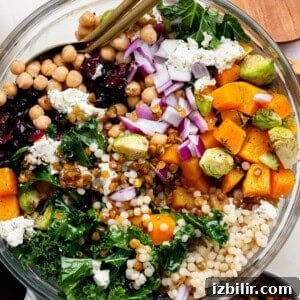 Autumn Couscous Salad Recipe with Seasonal Veggies 6 A vibrant couscous salad featuring roasted vegetables and grains served with utensils.