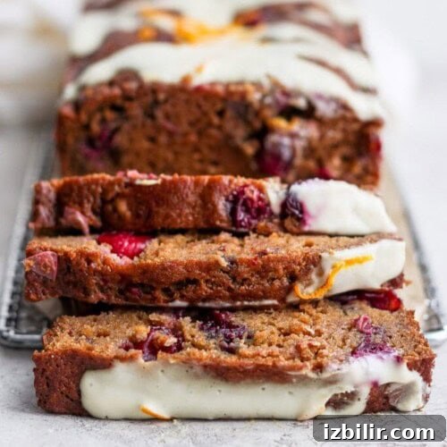 Thanksgiving Sides Worth Serving (Everything But Turkey) 32 A loaf of cranberry orange bread topped with icing.