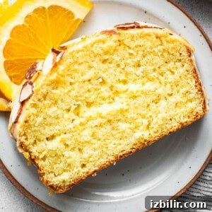 A slice of orange pound cake on a plate.