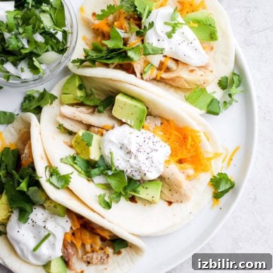 Shredded chicken tacos on a plate