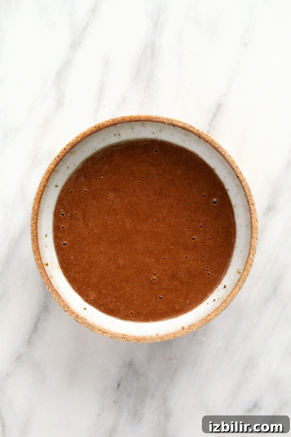 chocolate mug cake batter in a mug, ready to be baked or made in the microwave